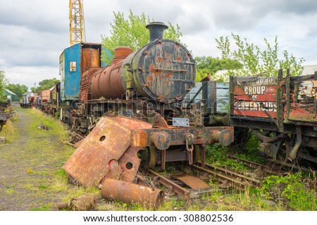 TANFIELD, UK, AUGUST 19th, 2015.  Rusty Steam train with a crane on a carriage, in the scrap yard at Tanfield Railway, the oldest railway in the world.