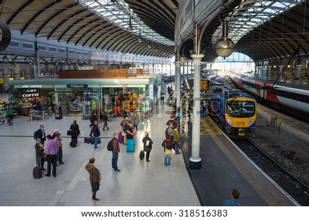 NEWCASTLE, UK, SEPTEMBER 15th, 2015. People waiting to board a train at the main platform of Newcastle Central Station.