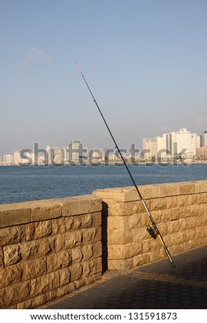 Fishing in the sea, Tel Aviv at background