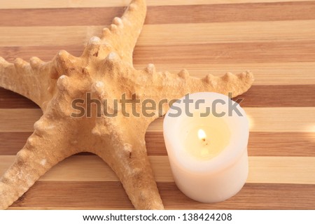 Still-life on the sea with candle and sea star