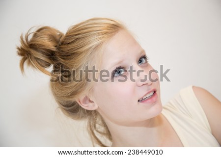 Portrait of young beautiful girl blonde hair bun