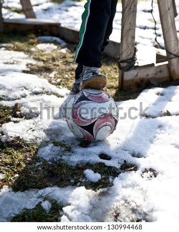 Boy longing for a game of soccer after a long winter break