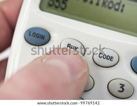 Pressing the buy button to complete an electronic transaction