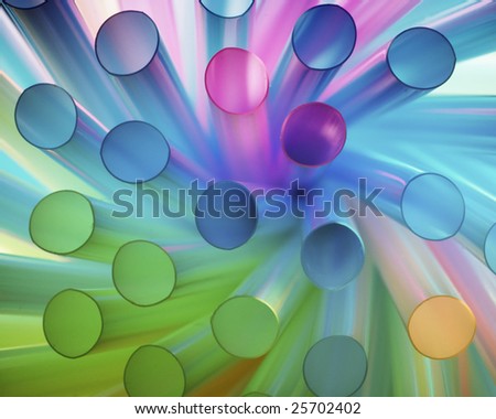 A cluster of colored plastic straws which have been twisted into an abstract swirl and lit brightly.