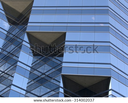 glass and metal business building with geometric patterns
