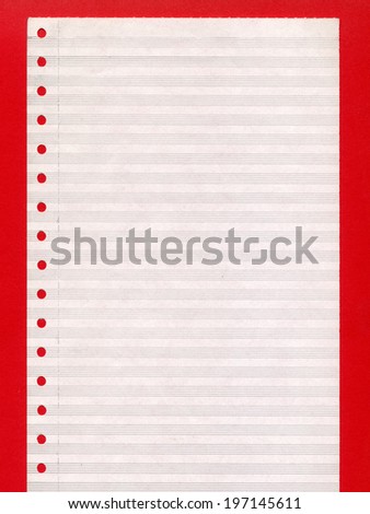 Blank perforated computer paper over red background
