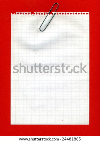 Image of metal clip on squared sheet of paper