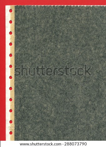 Perforated carbon copy paper over red background