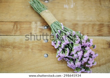 Closeup image of purple wedding flower bouquet decoration on wooden background, wedding concept