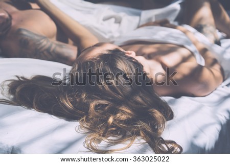 beautiful young man and woman in the morning in bed . Gentle morning together. \
(author\'s style treatment of light and color)