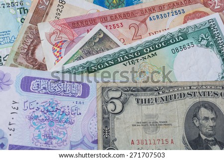 Foreign money collage background.  Bank notes from different countries randomly arranged for a background.