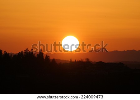 Big Orange Sunset and Mountain Silhouette