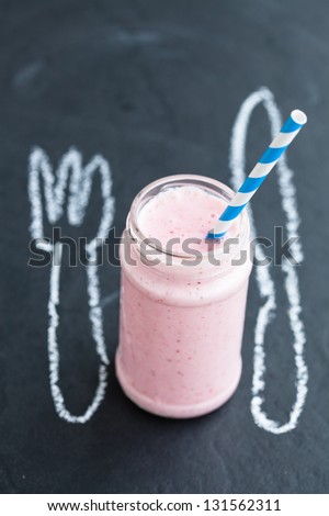 Strawberry smoothie with striped straw with knife and fork chalk drawing
