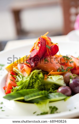 Delicious smoked salmon salad on an outdoor restaurant table