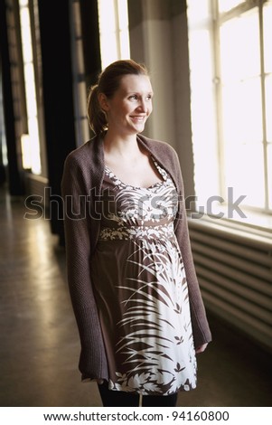 Portrait of pregnant mother. Natural portrait in an indoor location.