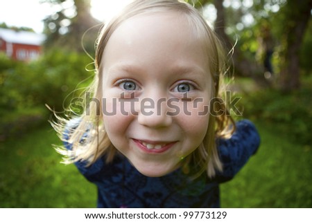 Little girl outdoors on a beautiful summer afternoon
