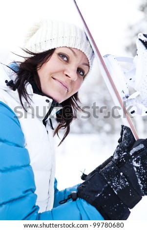 Portrait of a female snowboarder with snowboard in beautiful cold winter weather