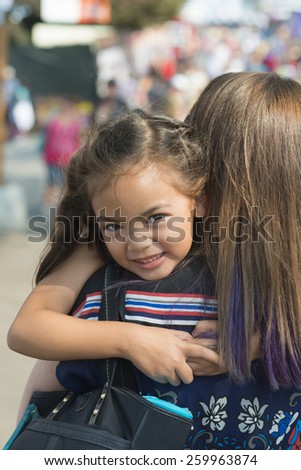 happy girl hugs mom / because that\'s what little kids / they just like to do