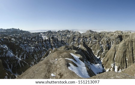 Badlands National Park after an early spring snowfall. The park, in southwestern South Dakota, consists of 244,000 acres of eroded buttes, pinnacles and spires surrounded by a prairie ecosystem.