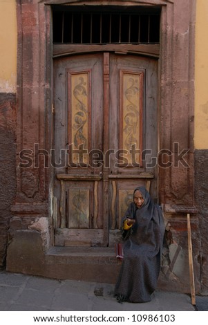 Peasant woman sitting in doorway in San Miguel de Allende, Mexico