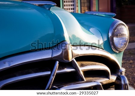Classic car restoration detail in sunset. Nice Chrome bumper.
