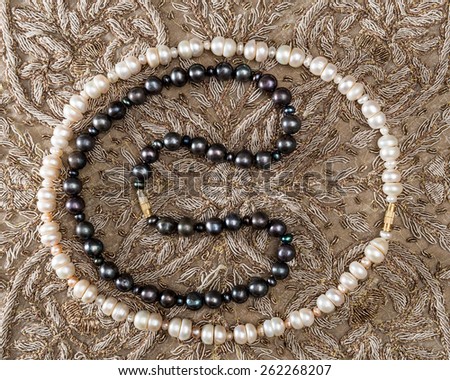 Bead of white and black pearls from India .