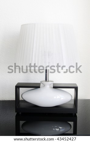 Desktop elegant lamp with a white lamp shade