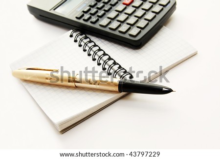 Note notepad in a cage, a pen pen and the countable machine on a white background