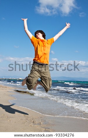 The young man jumps on sand at the sea