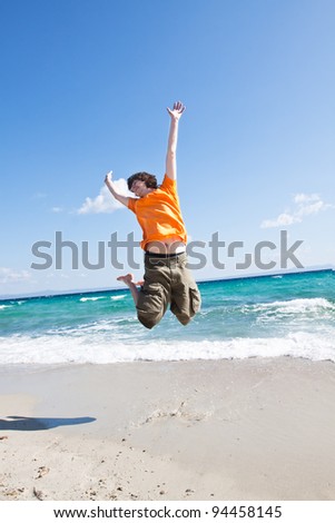 The young man jumps on sand at the sea