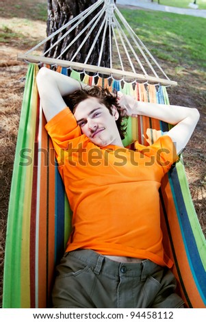 The young man has a rest in a hammock, summer