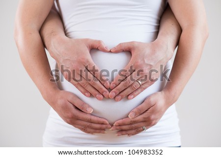 Heart Shaped Hands of Pregnant Woman and Her Husband