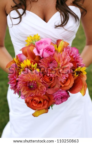 Bride Holding Wedding Bouquet with Orange and Pink Flowers