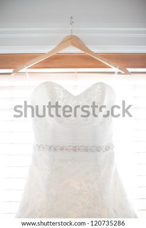 Wedding Dress Hanging in a Window