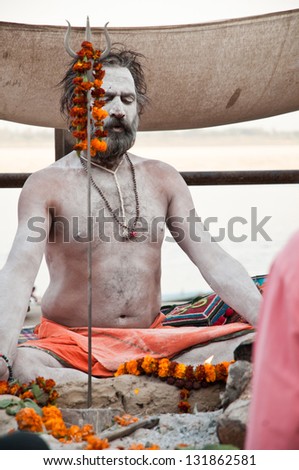 VARANASI, INDIA - MARCH 10: A hindu saint meditates during rituals of Lord Shiva prayer on the auspicious Maha Shivaratri festival on March 10, 2013 at Varanasi, Uttar Pradesh, India.