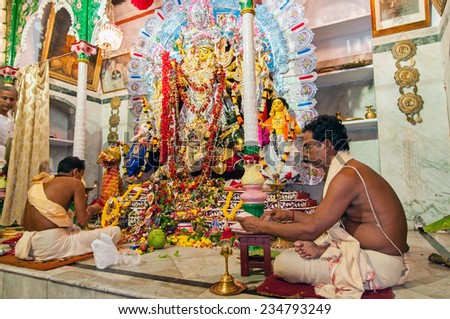 KOLKATA - OCTOBER 2: Unidentified hindu priests worship goddess Durga during the festival of Dussera on October 2, 2014 at Jorasanko, Kolkata, India. It is one of the oldest Durga Puja in Kolkata.