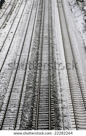 multiple meter gauge railway lines covered with snow