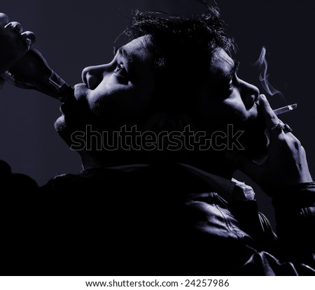 portrait showing the dark side of life with a sad man smoking and drinking