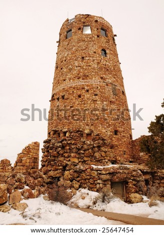 an old run down lighthouse make of brick covered with snow in winter at grand canyon national park