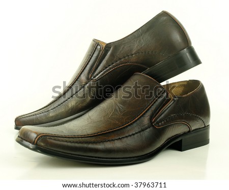 Stylish pair of semi-formal shoes displayed in an attractive arrangement isolated over white