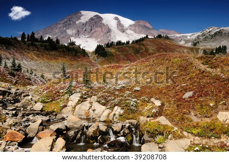 Majestic Mount Rainier blushing with valleys covered with fall colors
