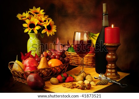 Beautiful still life image of red wine, fruits and nuts with dramatic lighting
