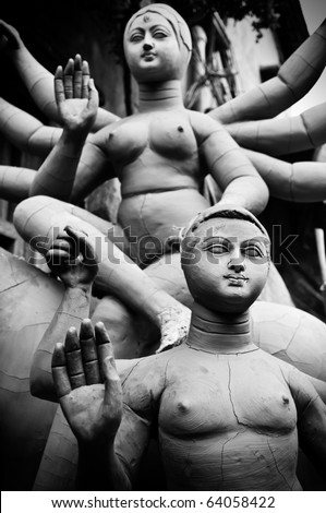 Old clay idol of ten handed Durga goddess and Karthik of Hindu religion in subtle black and white tone