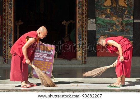 SIKKIM, INDIA - OCTOBER 27: Unidentified Tibetan monks clean the monastery floor before the start of morning prayer ceremony at Rumtek on October 27, 2011 in Sikkim, India. Rumtek is the largest monastery in Sikkim.