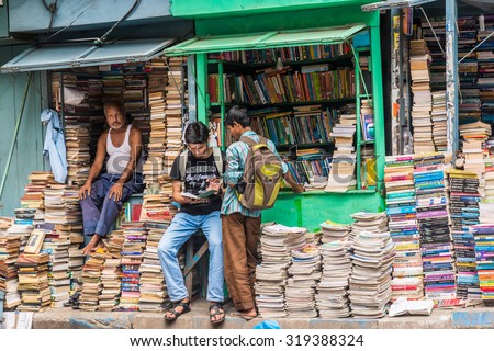 KOLKATA, INDIA - AUGUST 22: Unidentified students check out books at an old street side book stall on August 22, 2015 at College Street Book Market in Kolkata, West Bengal, India.