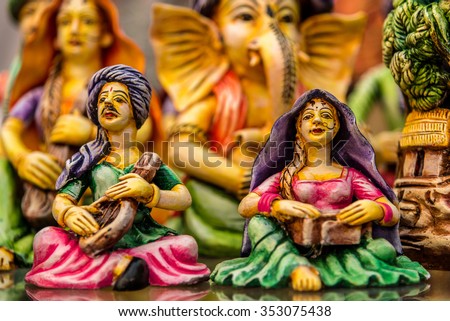 Miniature clay puppets of rural couple playing classical music instruments
