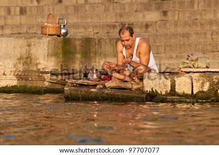 VARANASI, INDIA - FEBRUARY 19: A Hindu brahmin priest offers prayers on the bank of holy Ganges river on the auspicious Maha Shivaratri festival on February 19, 2011 at Varanasi, Uttar Pradesh, India.