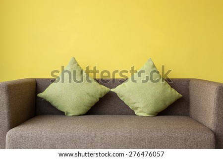Interior design by brown sofa and green pillow in living room