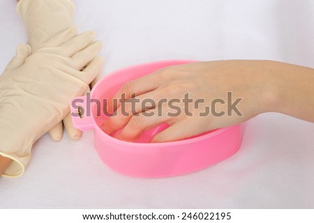 step of manicure process: fingers soaking in warm water