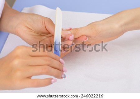 step of manicure process: nails shaping using nail file